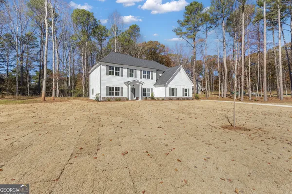a view of an empty room with chandelier fan
