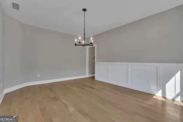 a kitchen with granite countertop white cabinets stainless steel appliances a sink and a window
