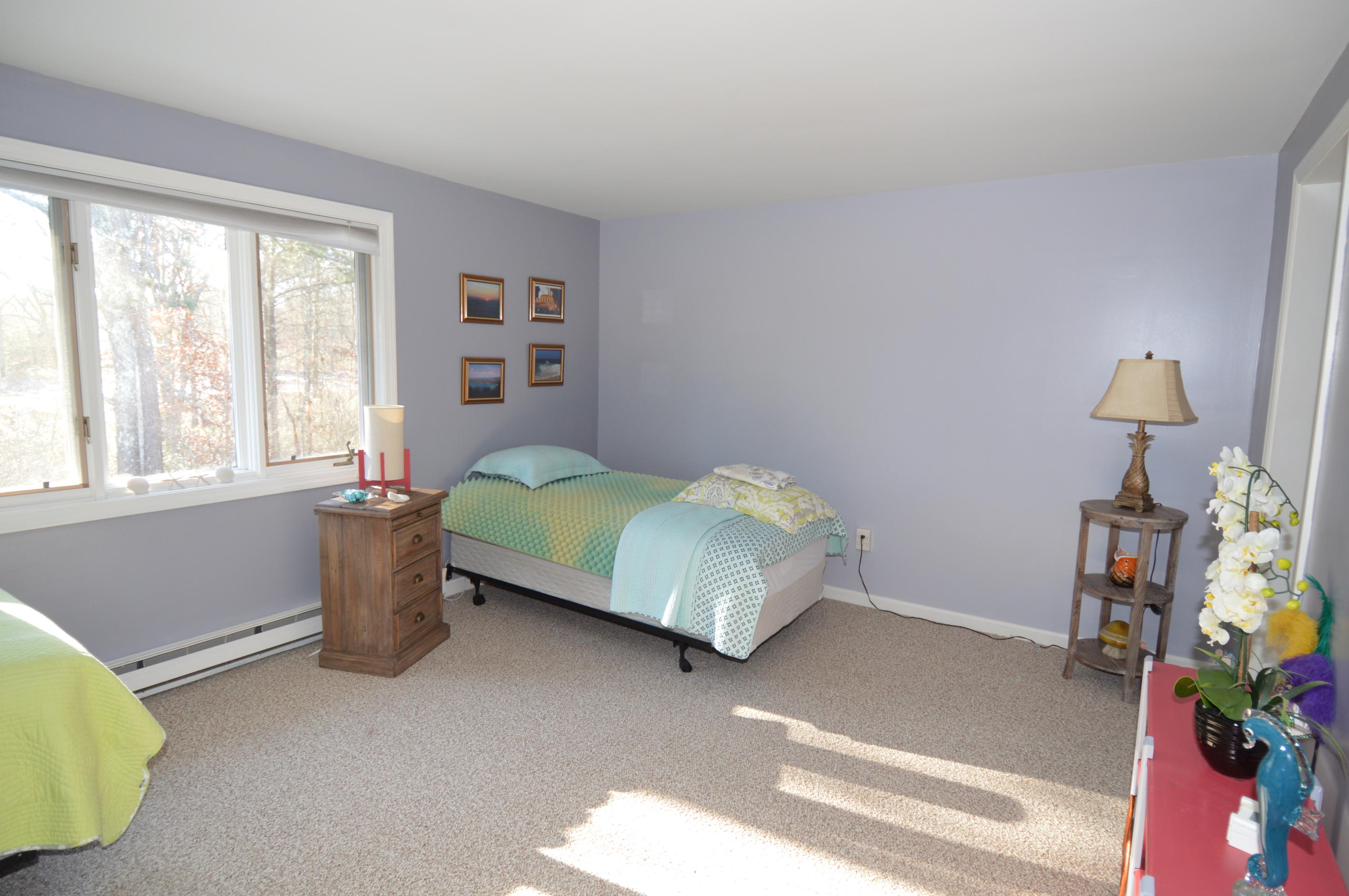 174 Lowell Road, Unit T30 Mashpee, MA 02649 - Photo 13 of 19 a bedroom with a bed and a window