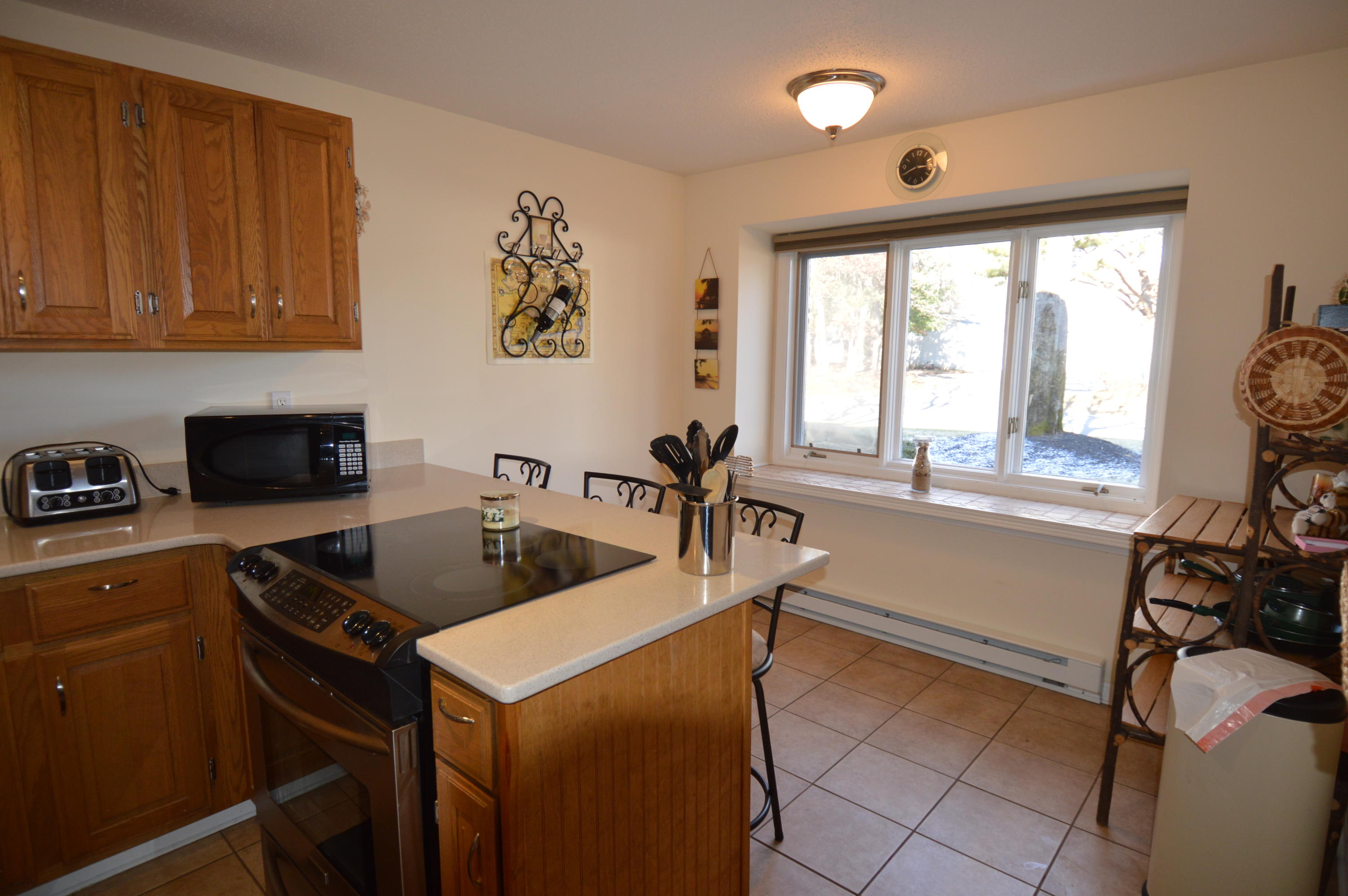 174 Lowell Road, Unit T30 Mashpee, MA 02649 - Photo 5 of 19 a kitchen that has a sink and a stove in it