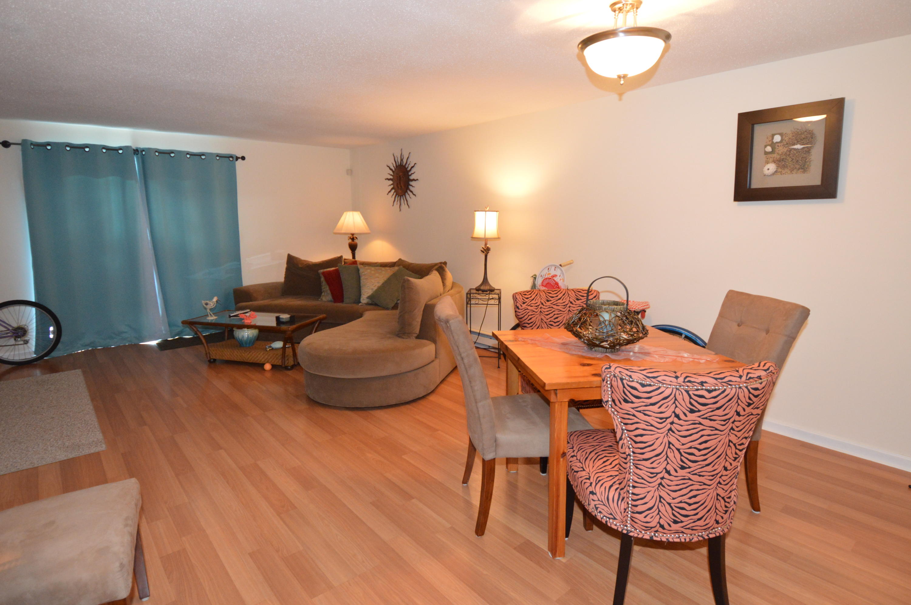 174 Lowell Road, Unit T30 Mashpee, MA 02649 - Photo 8 of 19 a dining room with furniture and wooden floor