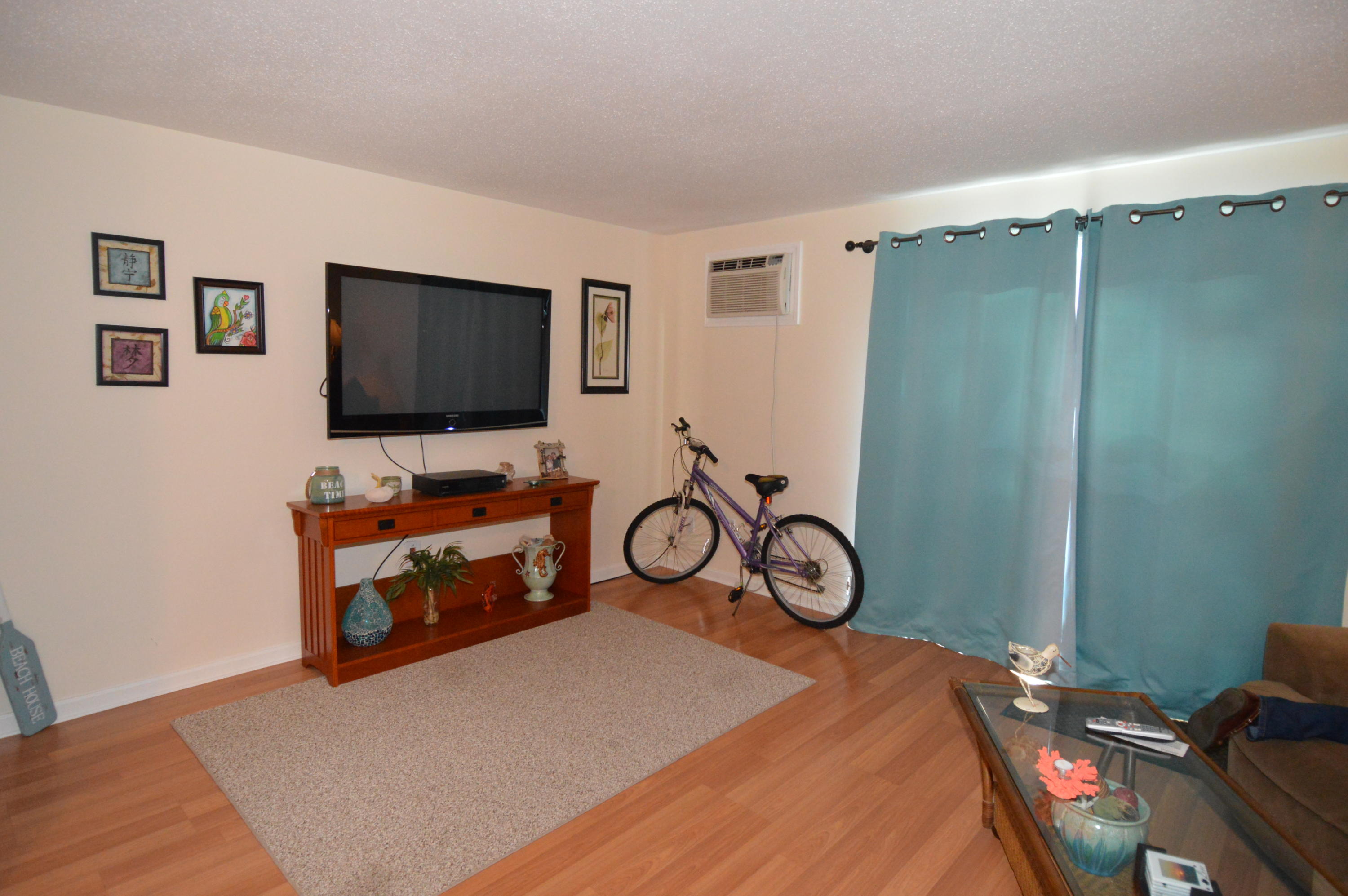 174 Lowell Road, Unit T30 Mashpee, MA 02649 - Photo 9 of 19 a bedroom with a bed and a flat screen tv