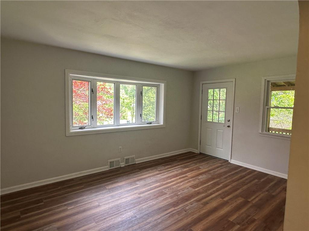201 Clever Road McKees Rocks, PA 15136 - Photo 3 of 30 an empty room with wooden floor and windows