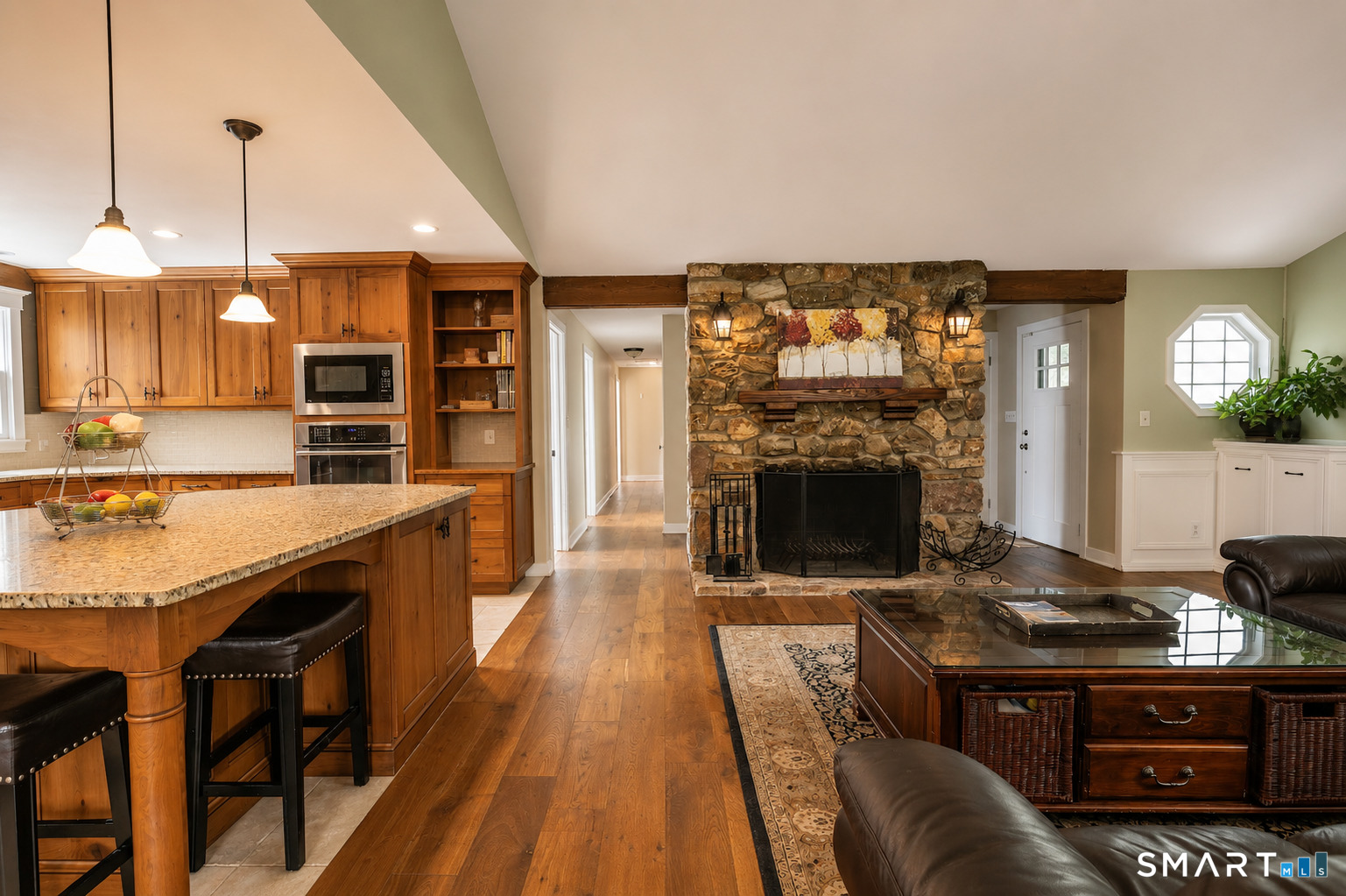193 R Blue Hills Road Durham, CT 06422 - Photo 6 of 30 a open kitchen with granite countertop a stove top oven a sink dishwasher and a fireplace with wooden floor