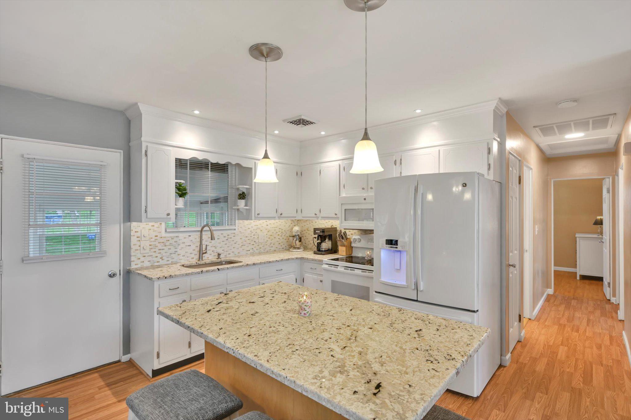 116 Swarthmore Drive Lititz, PA 17543 - Photo 11 of 34 a large kitchen with kitchen island a wooden floor and a chandelier