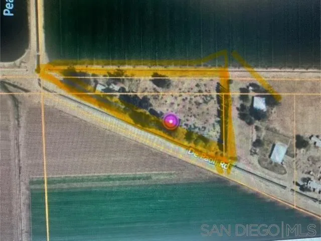 a view of a lake with houses in the back