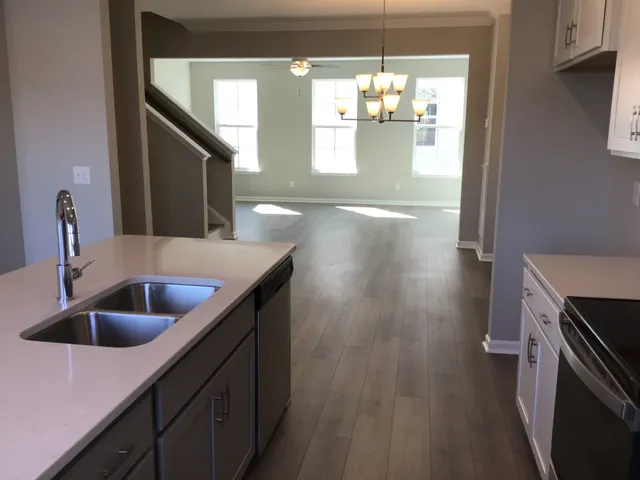 a kitchen with a sink a refrigerator and window