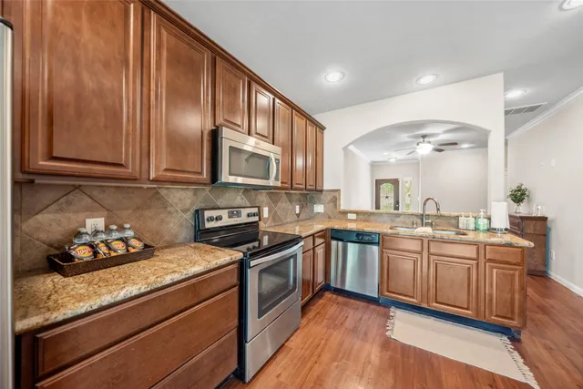 a kitchen with lots of counter space and wooden floor