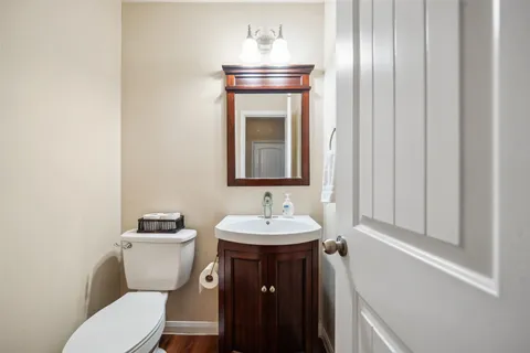 a bathroom with a toilet sink and mirror