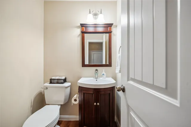 a bathroom with a toilet sink and mirror