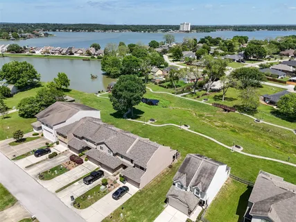an aerial view of a house with a garden and lake view
