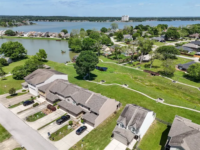 an aerial view of a house with a garden and lake view