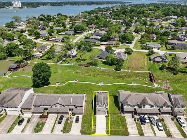 an aerial view of a houses with a yard