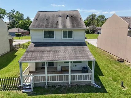 a view of a house with a yard and deck