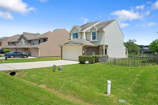 a front view of a house with a garden and yard