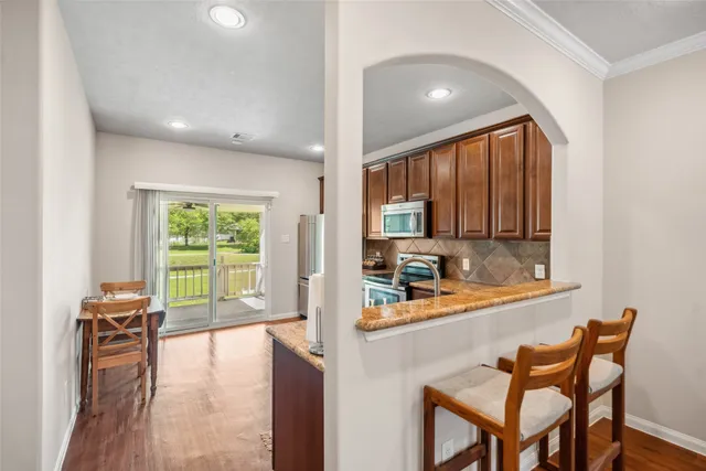 a dining room with furniture and a floor to ceiling window