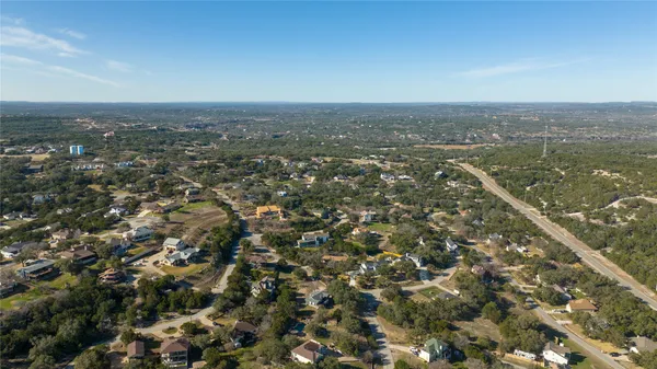 an aerial view of residential houses with city view
