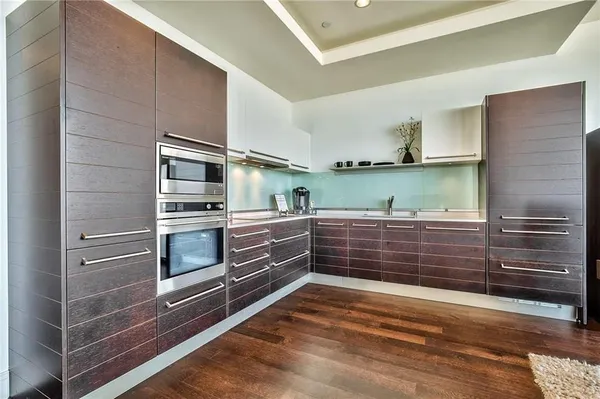 a kitchen with stainless steel appliances and cabinets