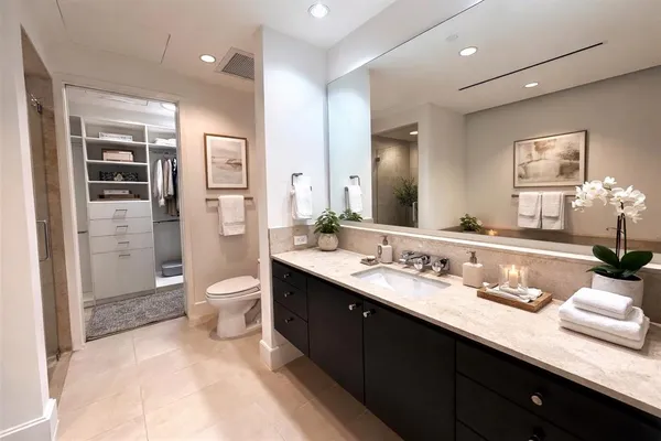 a spacious bathroom with a granite countertop sink mirror and toilet