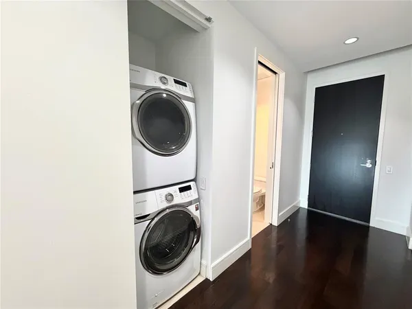 a view of a hallway with washer and dryer