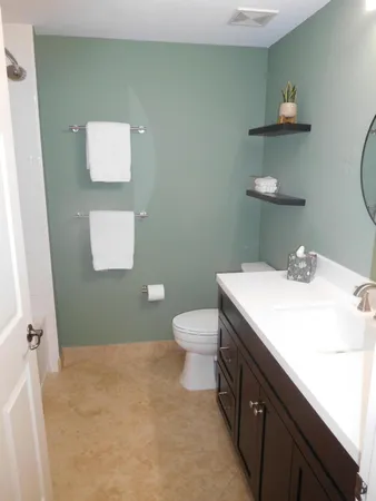 a bathroom with a sink a toilet and mirror