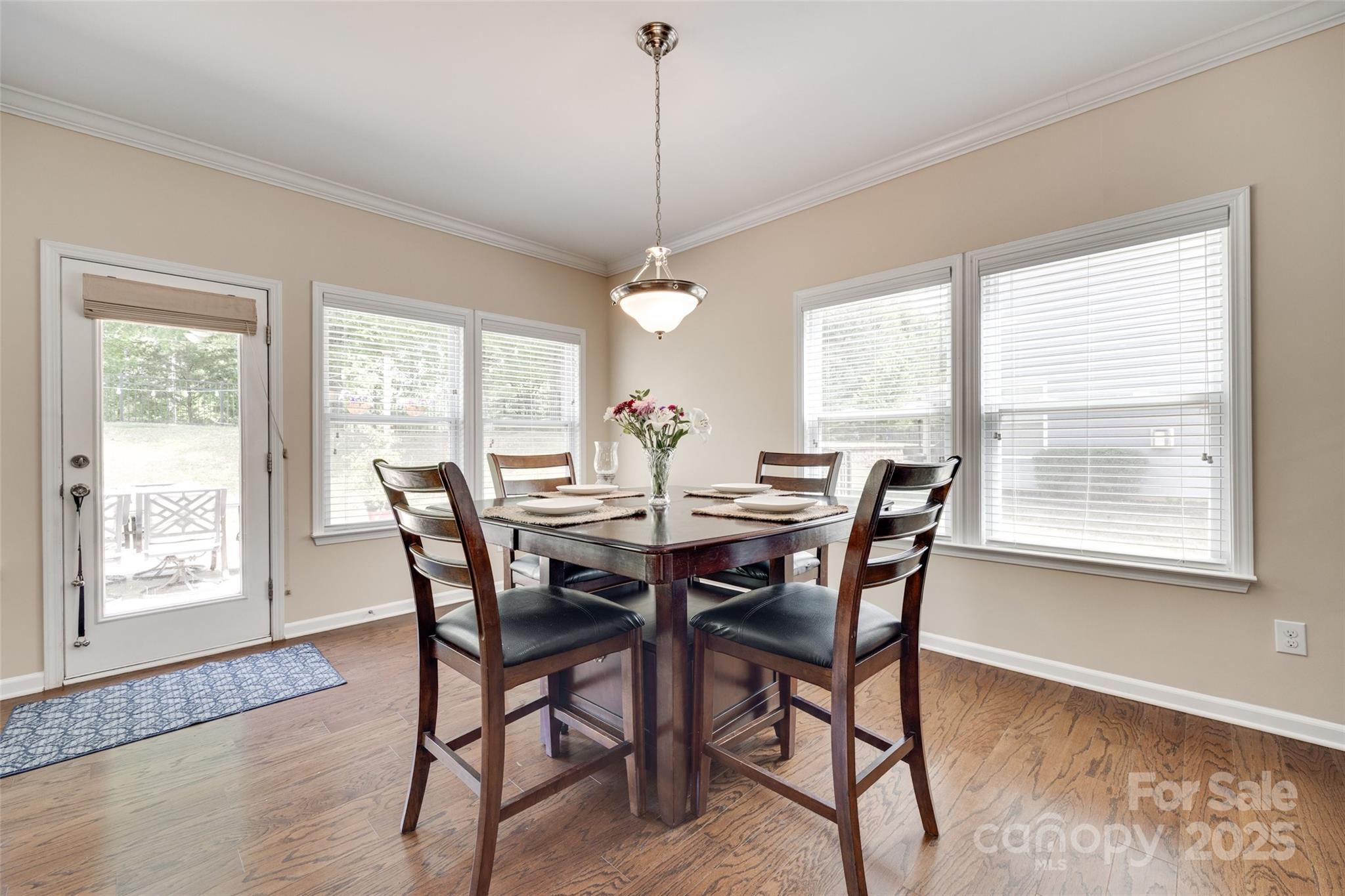 985 Angelica Lane Tega Cay, SC 29708 - Photo 13 of 47 a view of a dining room with furniture window and wooden floor