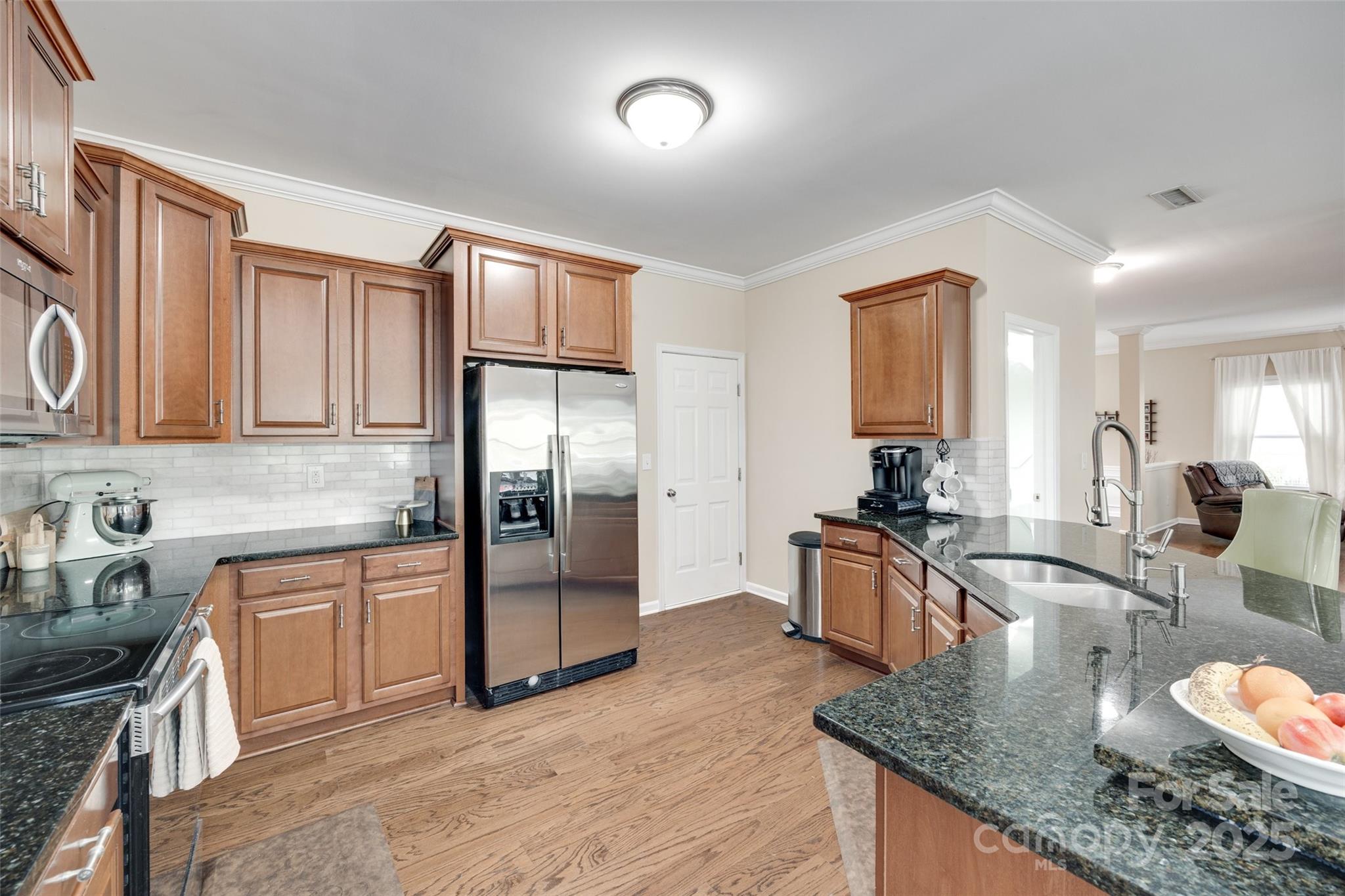 985 Angelica Lane Tega Cay, SC 29708 - Photo 15 of 47 a kitchen with stainless steel appliances granite countertop a sink refrigerator stove and microwave