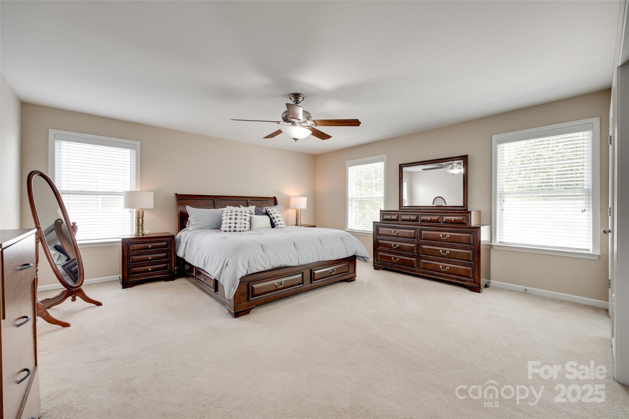 985 Angelica Lane Tega Cay, SC 29708 - Photo 30 of 47 a bedroom with a bed next to a window with a chandelier