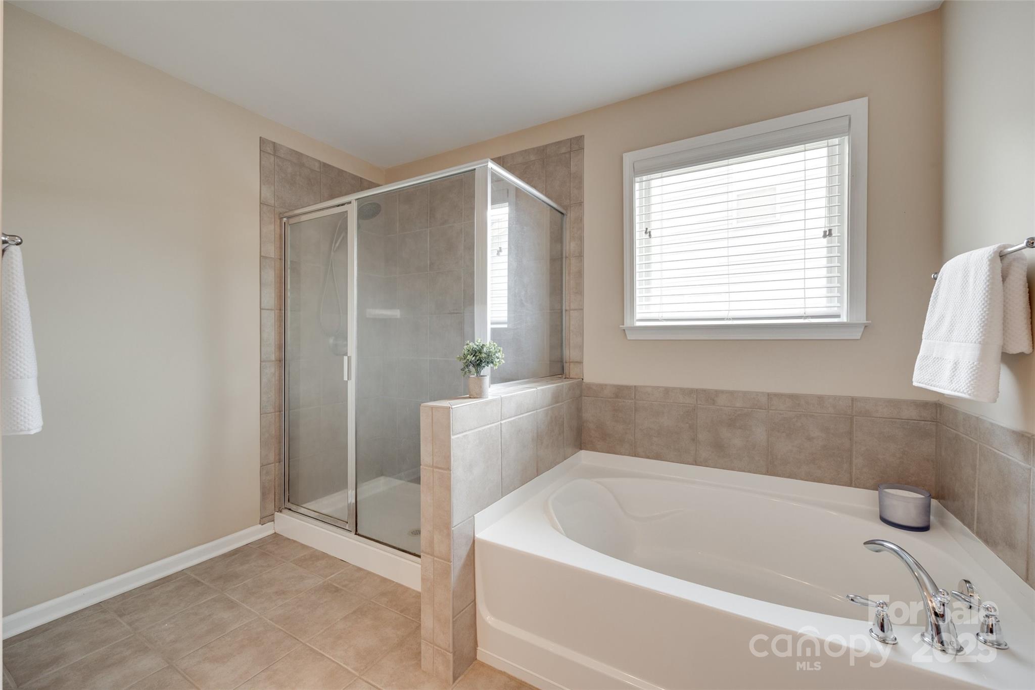 985 Angelica Lane Tega Cay, SC 29708 - Photo 33 of 47 a white bath tub sitting in a bathroom next to a window