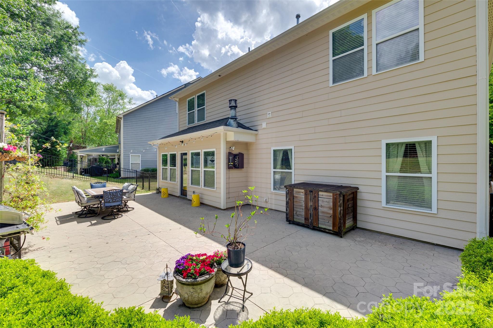 985 Angelica Lane Tega Cay, SC 29708 - Photo 34 of 47 a view of a house with backyard sitting area and garden