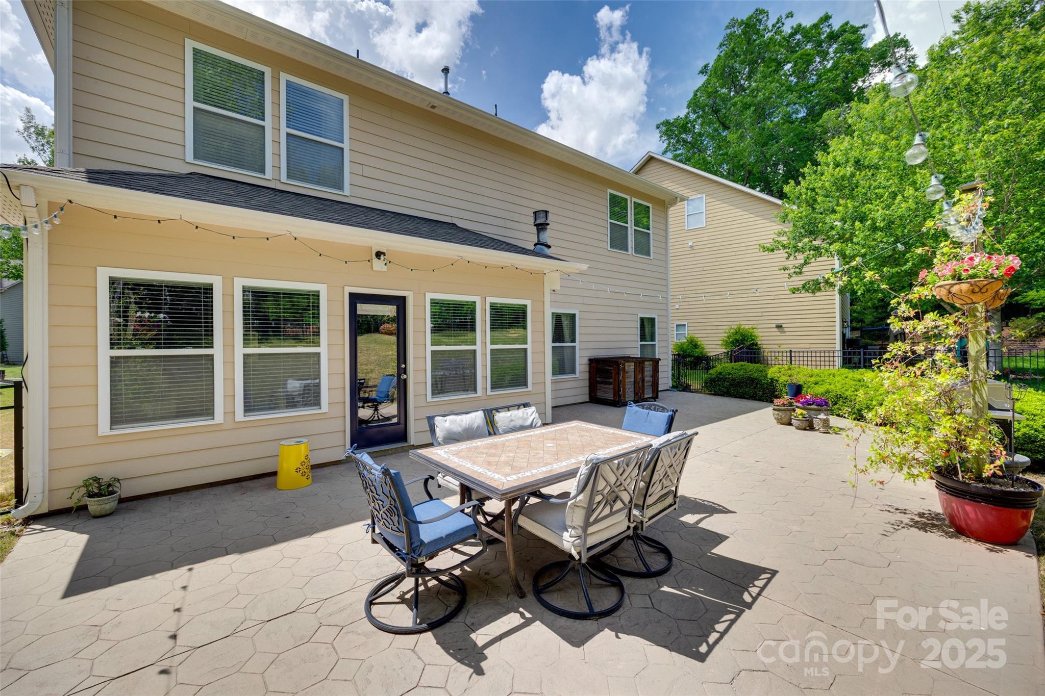 985 Angelica Lane Tega Cay, SC 29708 - Photo 35 of 47 a view of a house with backyard sitting area and garden