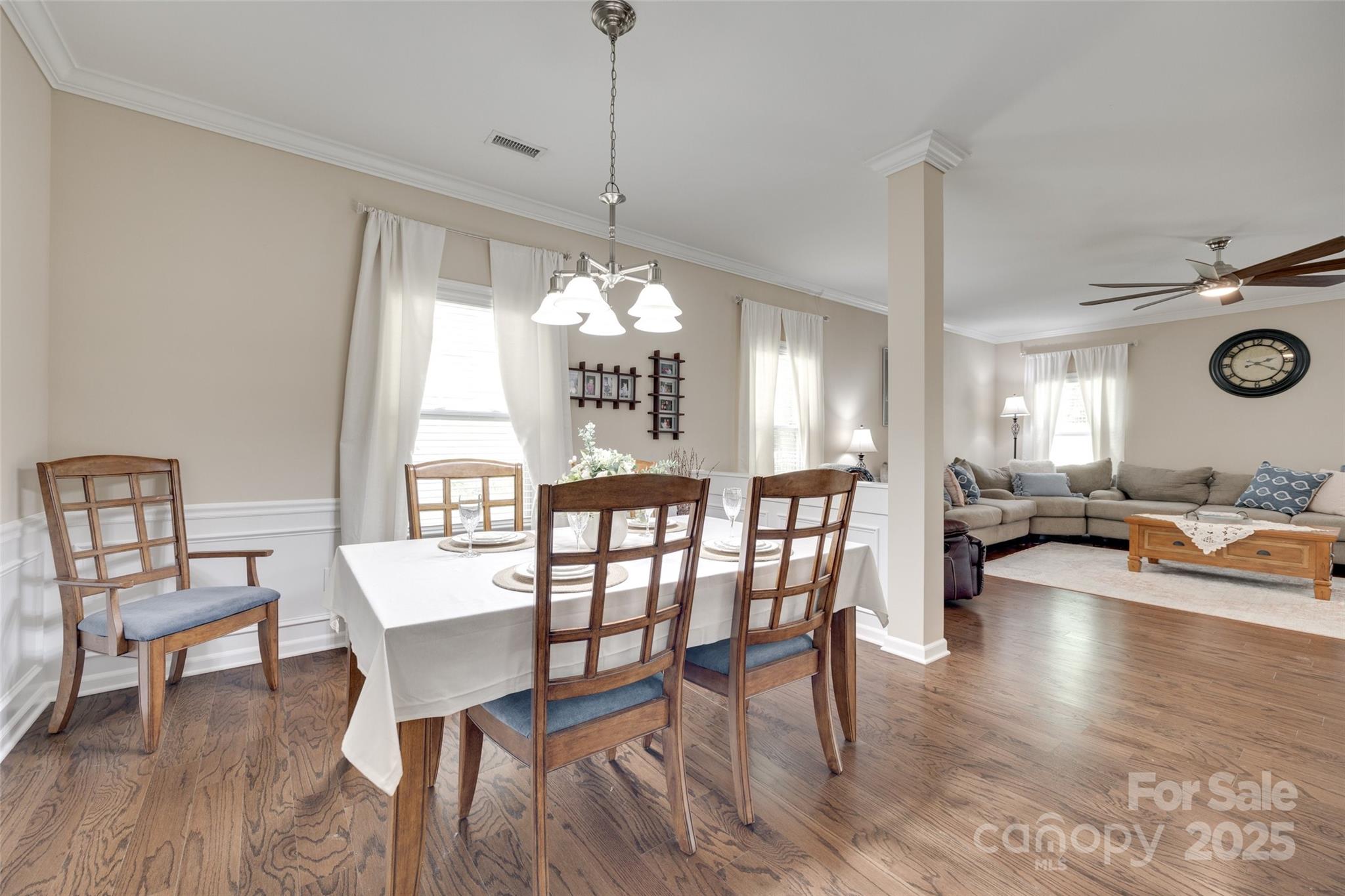985 Angelica Lane Tega Cay, SC 29708 - Photo 6 of 47 a view of a dining room and livingroom with furniture wooden floor a chandelier