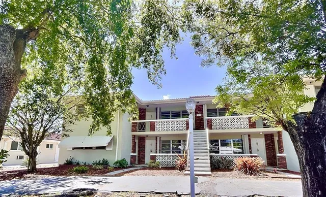 a front view of a building and trees