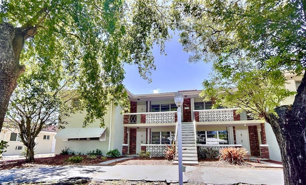 a front view of a building and trees