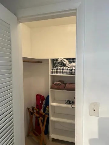 a living room with furniture and a curtain