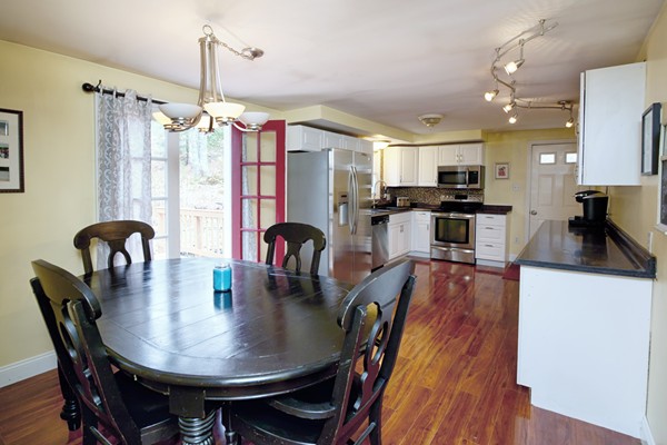 486 Cotuit Road Mashpee, MA 02649 - Photo 14 of 29 a view of a dining room and livingroom with furniture wooden floor a chandelier