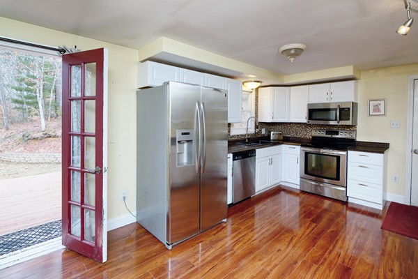486 Cotuit Road Mashpee, MA 02649 - Photo 15 of 29 a kitchen with wooden floors stainless steel appliances and window