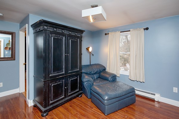 486 Cotuit Road Mashpee, MA 02649 - Photo 16 of 29 a living room with furniture and a flat screen tv