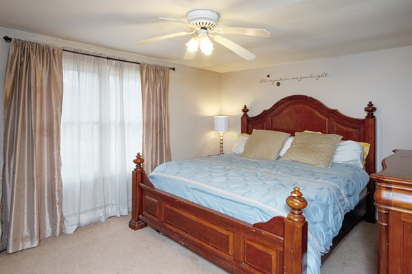 486 Cotuit Road Mashpee, MA 02649 - Photo 18 of 29 a bedroom with a bed and a chandelier