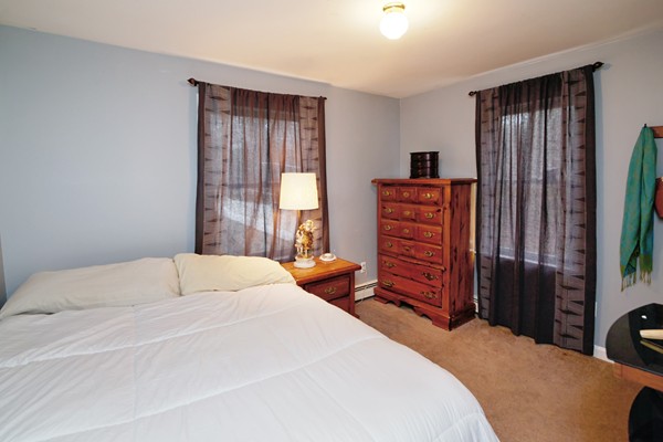 486 Cotuit Road Mashpee, MA 02649 - Photo 21 of 29 a bedroom with a bed and a dresser