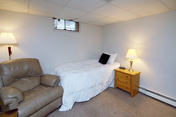 486 Cotuit Road Mashpee, MA 02649 - Photo 26 of 29 a bedroom with a bed and a lamp