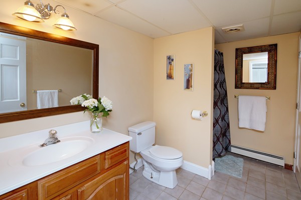 486 Cotuit Road Mashpee, MA 02649 - Photo 27 of 29 a bathroom with a sink mirror vanity and toilet