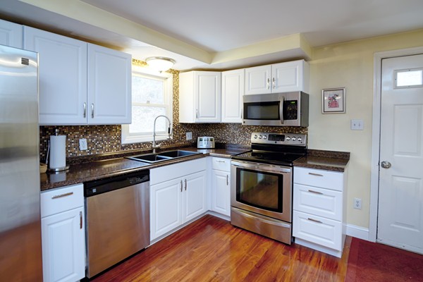 486 Cotuit Road Mashpee, MA 02649 - Photo 10 of 29 a kitchen with granite countertop a stove a sink and a microwave