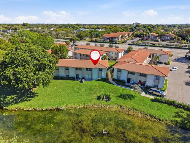 an aerial view of a house with yard swimming pool and outdoor seating