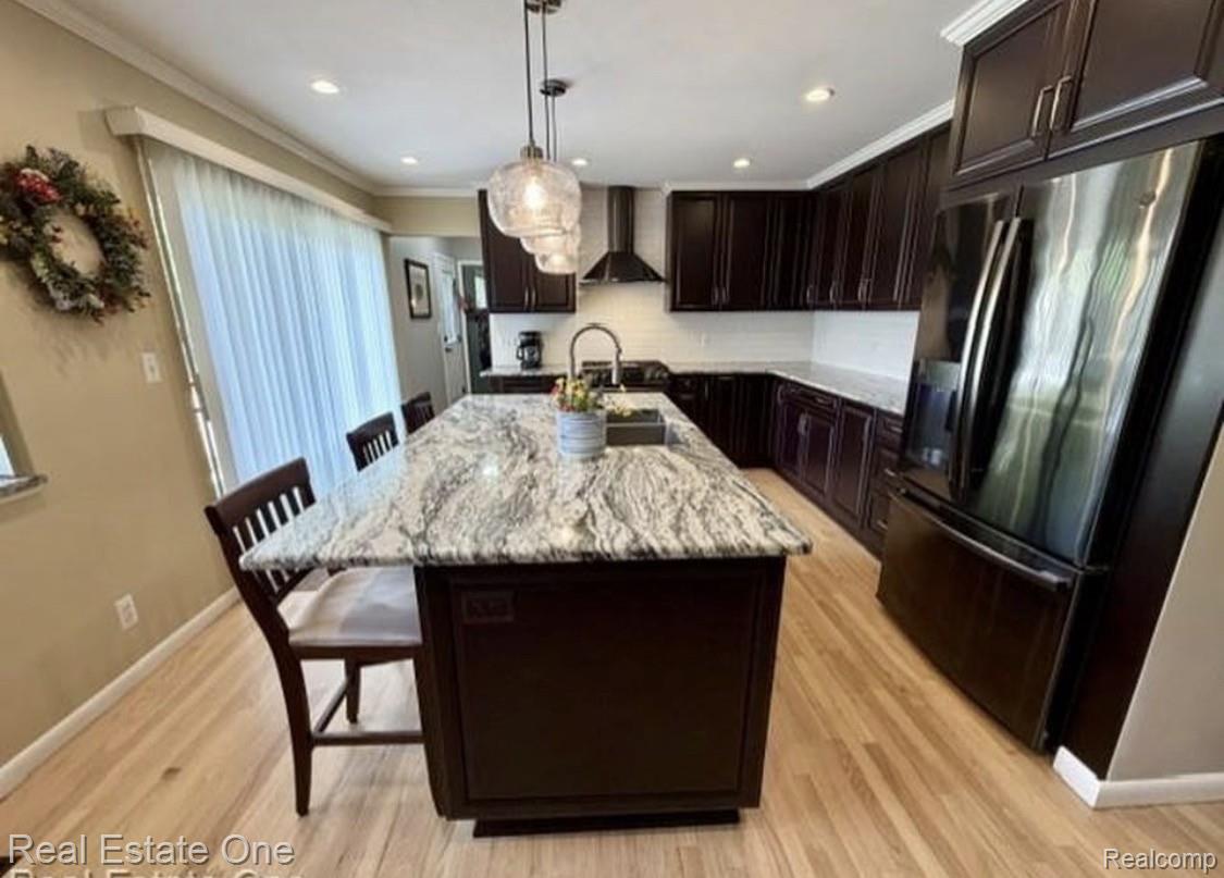 1115 Torpey Road Troy, MI 48083 - Photo 10 of 38 Expansive kitchen island featuring a light-toned countertop and pendant lighting