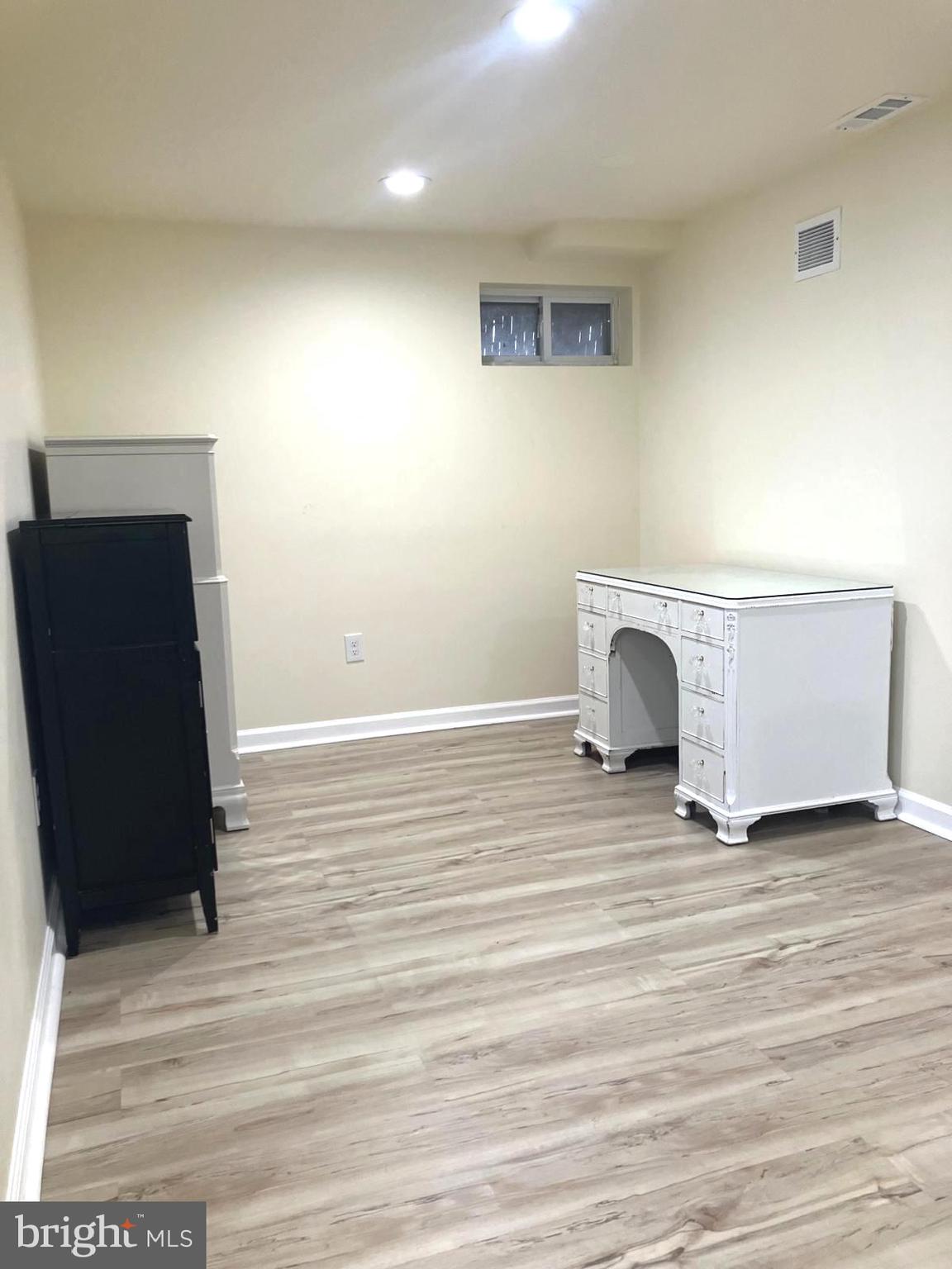 626 South Irving Street Arlington, VA 22204 - Photo 15 of 28 a view of an empty room with wooden floor and a window