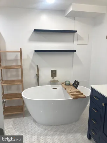 a white bath tub sitting in a bathroom
