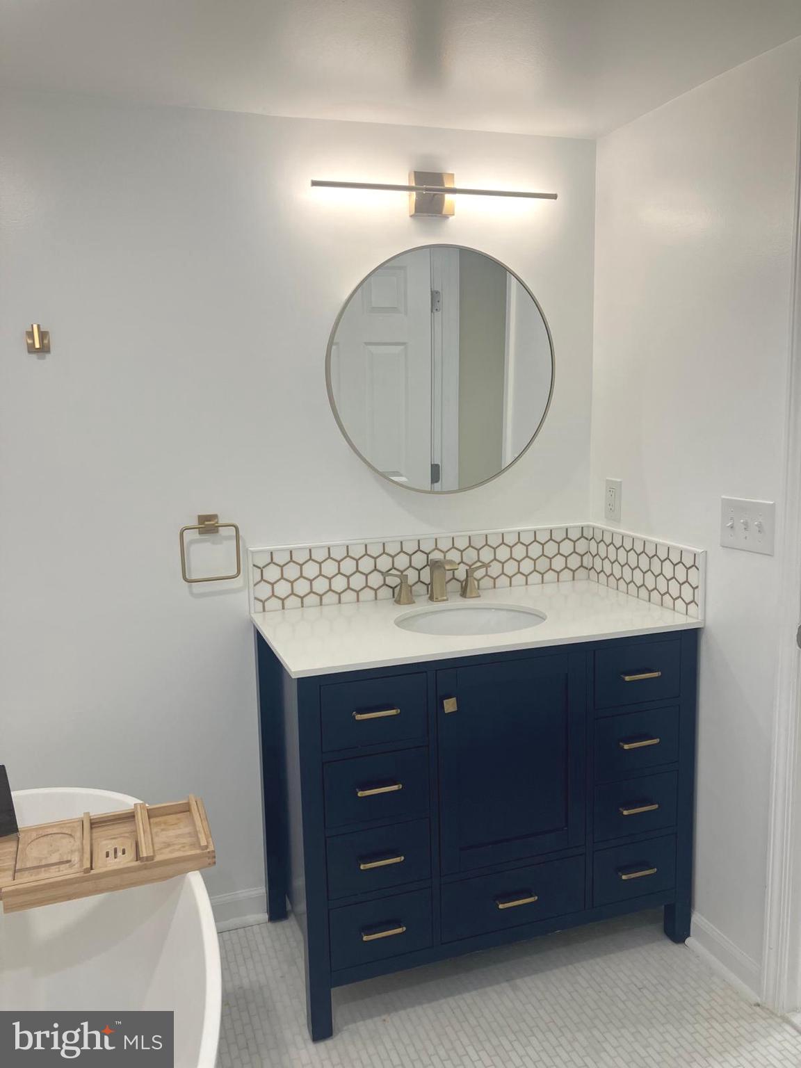 626 South Irving Street Arlington, VA 22204 - Photo 22 of 28 a bathroom with a granite countertop sink a mirror and vanity