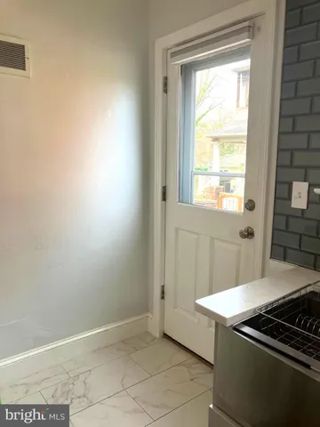 a kitchen with granite countertop white cabinets and a stove