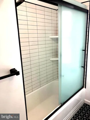 a bathroom with a shower and a sink